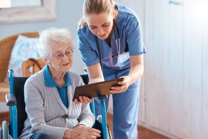 Nurse checking chart with patient