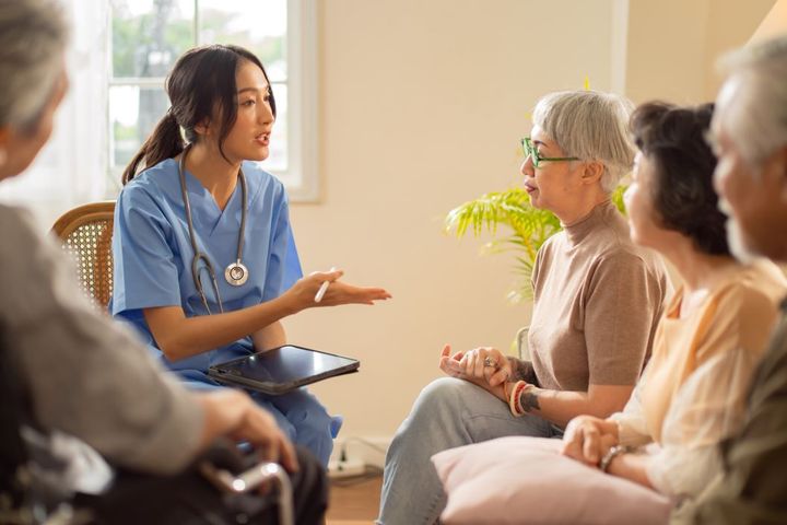 Nurse consulting group of patients