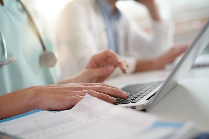A nurse works on their STNA cover letter to prepare for a job.