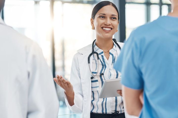 A healthcare administrator speaking with her staff.