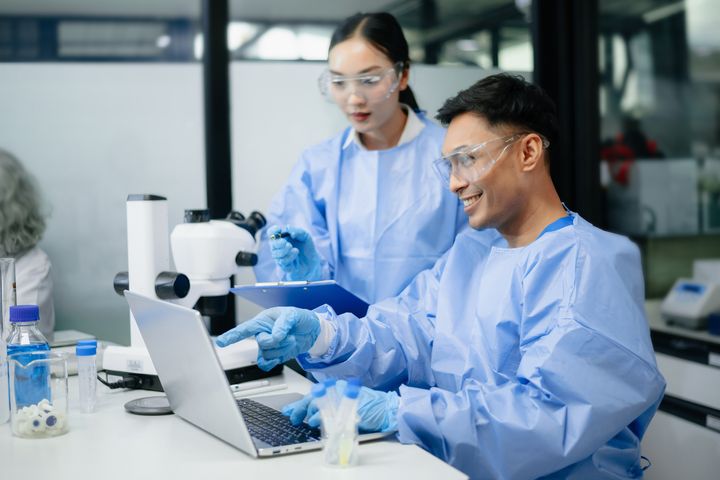 A biotech nurse inputs data into a computer program.