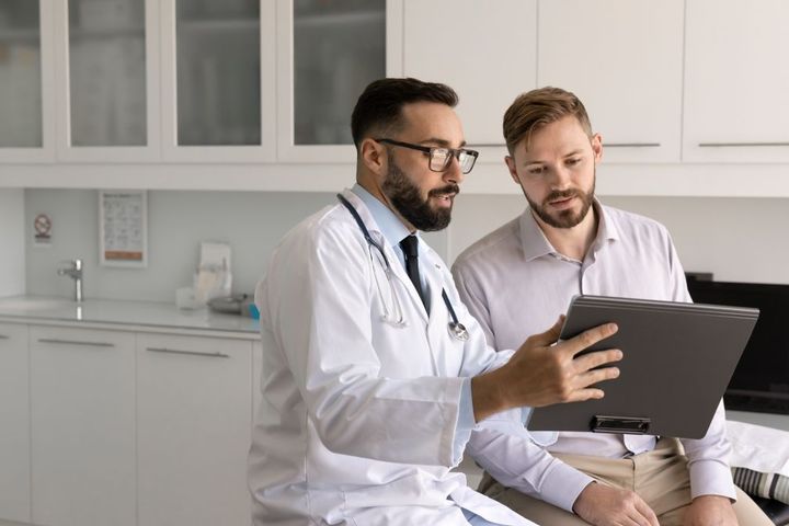 A physician goes over the treatment plan with a patient.