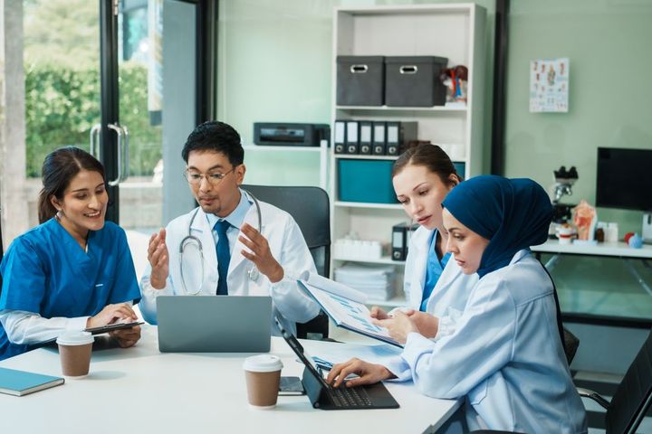 A team of healthcare providers engages in a care coordination session.