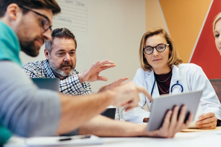 Image of healthcare professionals engaged in a change management meeting