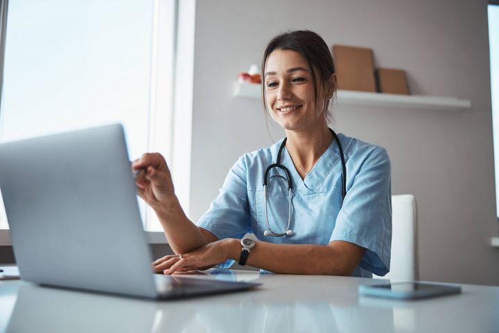 A healthcare worker works with a clinical decision support system to plan a patient's treatment plan.