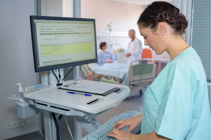 A nurse with CMGT-BC certification works on case management tasks.