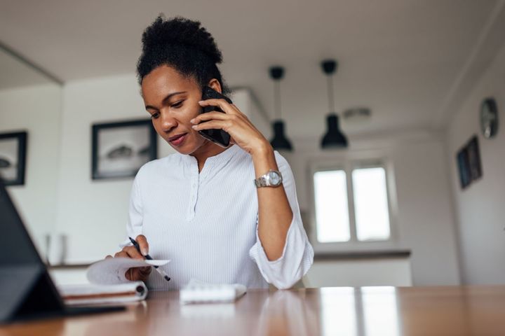 A job applicant answers common phone interview questions.