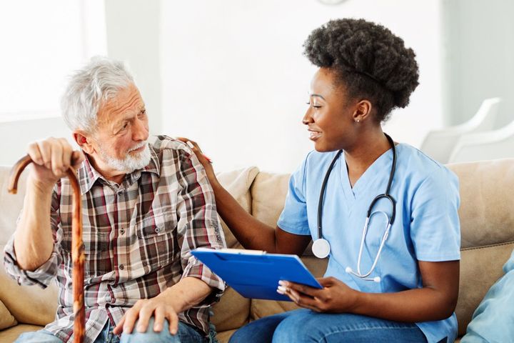 A nurse meets with a resident of the LTC facility where she works.