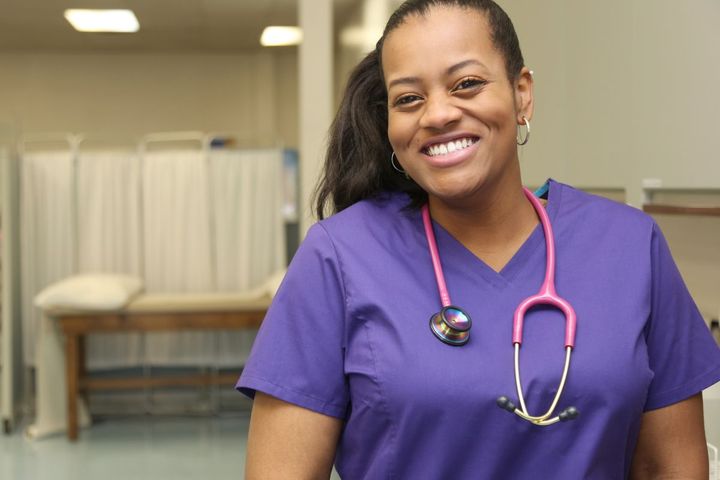 A correctional nurse smiles for the camera.