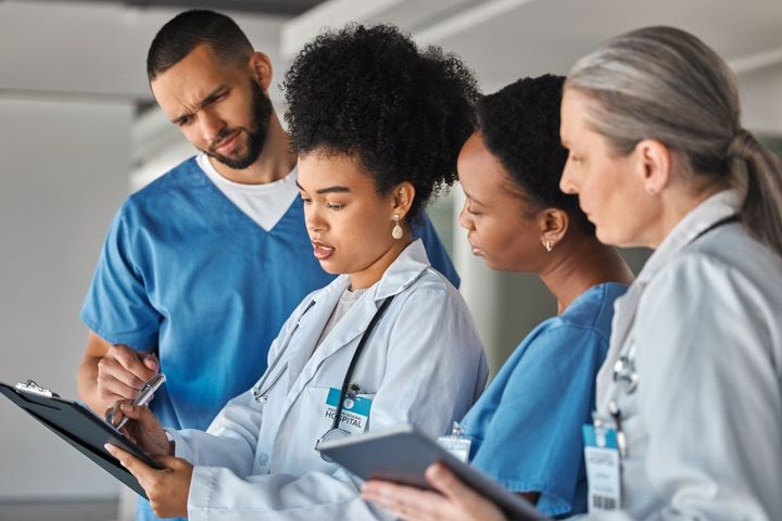 A group of physicians and nurses compares notes as they pursue cultural competency training.