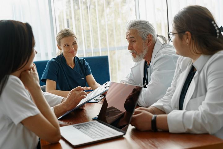 A team of physicians and nurses gather to discuss the CUSP model.