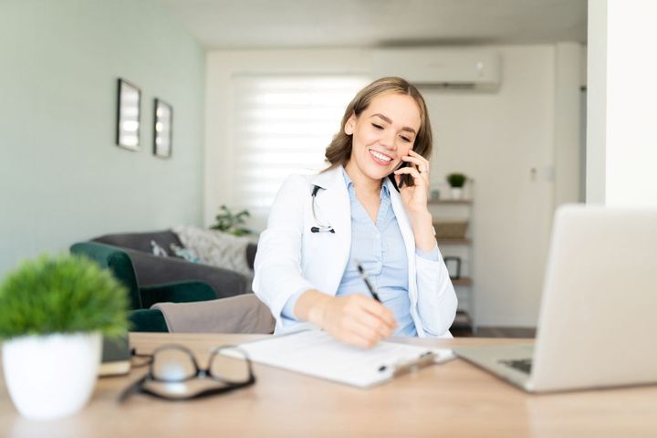 Female healthcare worker on phone call while at home