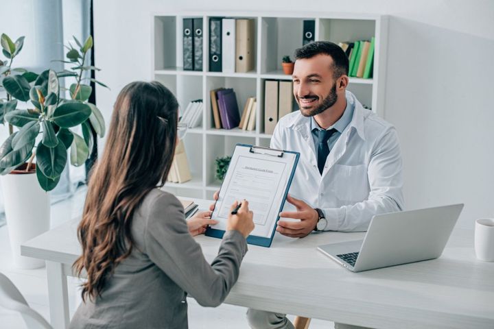 A physician talks to a patient about a claim.