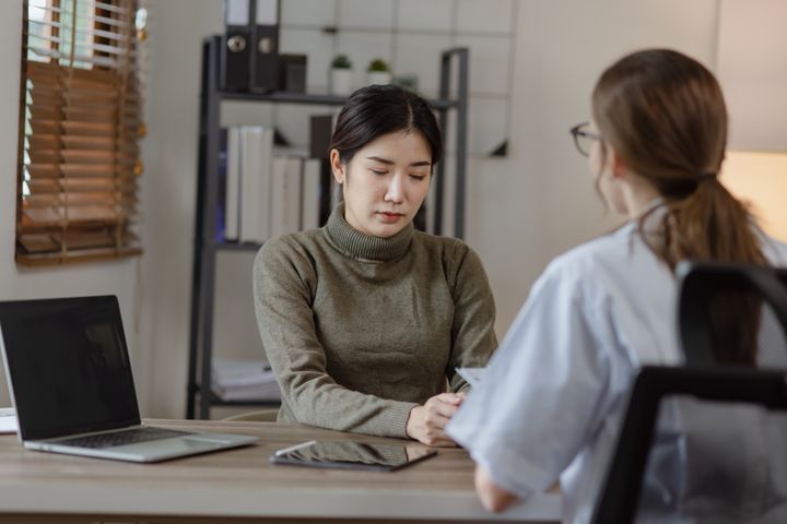 Healthcare administrator working on a Florida CNA background check with an applicant in an office