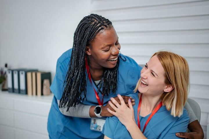 Two Florida CNAs share a moment of levity together.