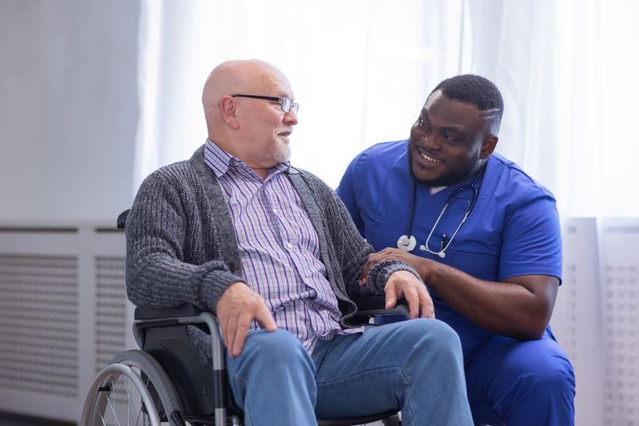 A Florida CNA talks with one of his patients.