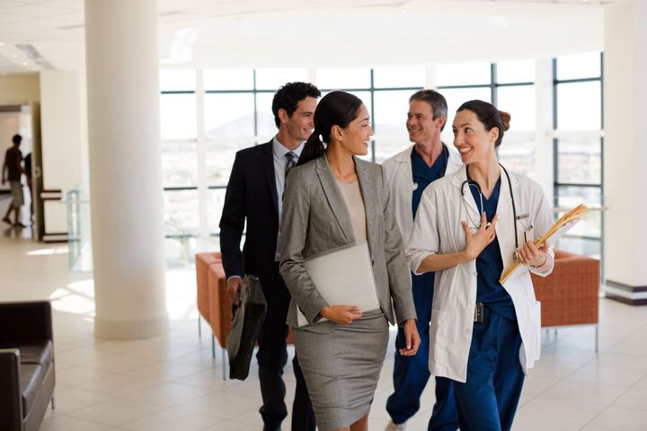 A healthcare compliance officer meets with senior hospital staff.