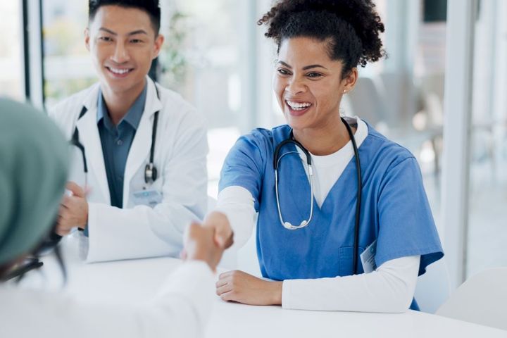 A newly hired nurse goes through the healthcare onboarding checklist with her new supervisor.