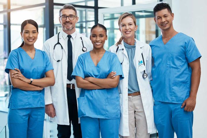 Nurses and doctors standing together at a hospital.