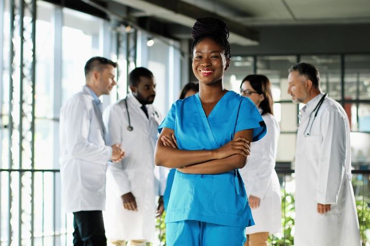 Young African-American nurse in blue scrubs