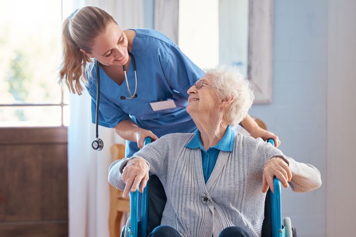 Certified Nursing Assistant helping a patient in a Florida care setting