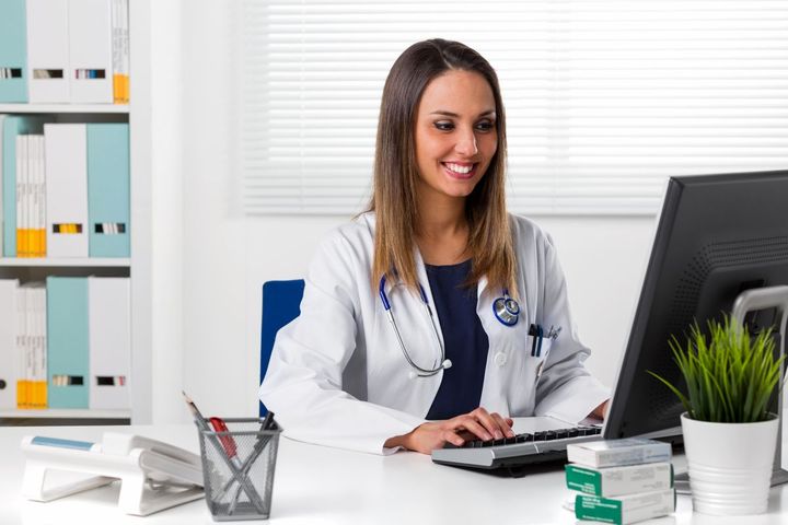 A physician checks the Google reviews of her healthcare clinic.