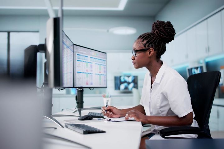 A healthcare worker checks a patient's data.