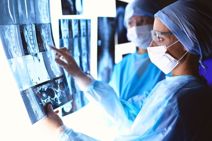 Two IR nurses examine X-rays.