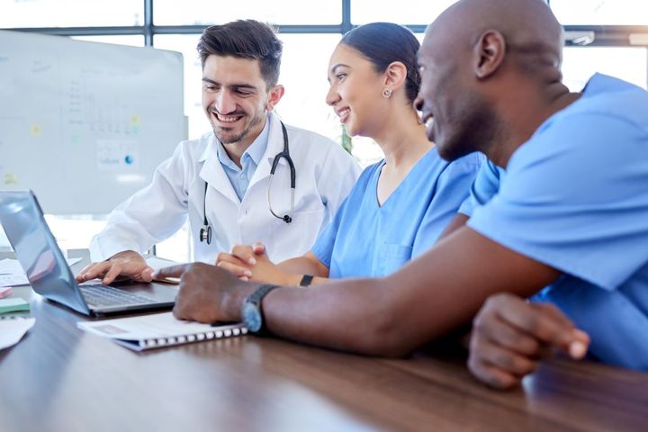 A team of nurses and physicians figuring out how best to promote their facility using social media marketing techniques.