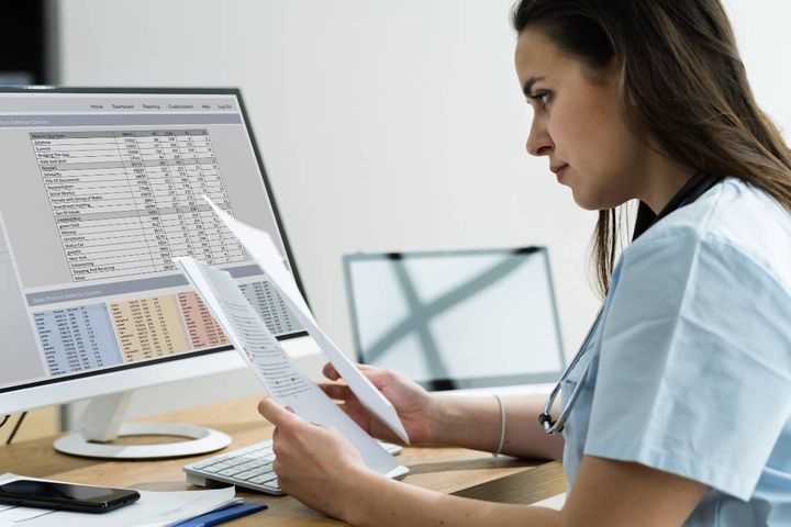 A healthcare worker works on an MDS in nursing homes.