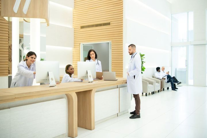 Medical building waiting room with doctors and patients