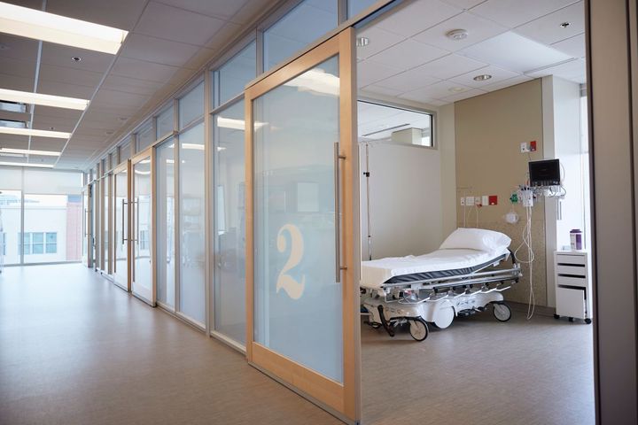 The hallway of a micro hospital, showing a room with a bed.