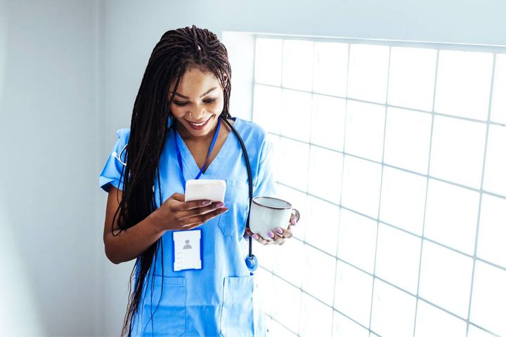 A healthcare worker browses the latest mobile apps for nurses on her phone.