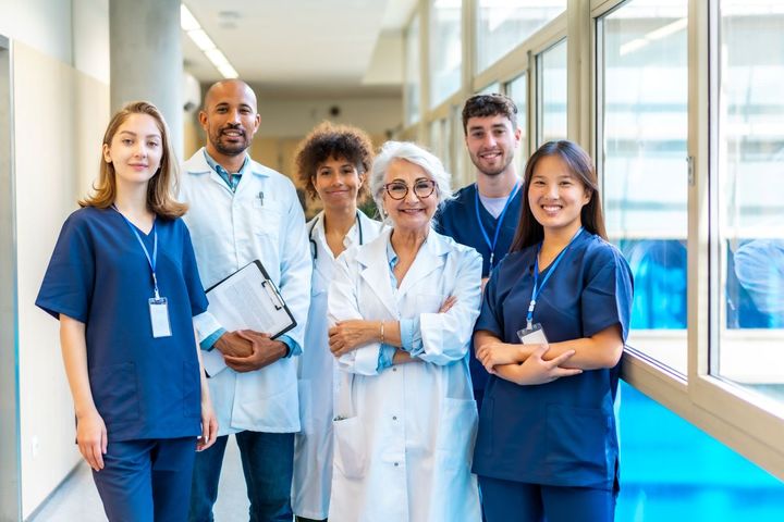 A team of healthcare workers poses for the camera after completing their NCQA accreditation.