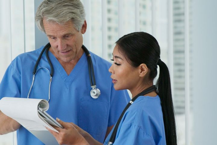 Two Nebraska nurses look at a chart together.
