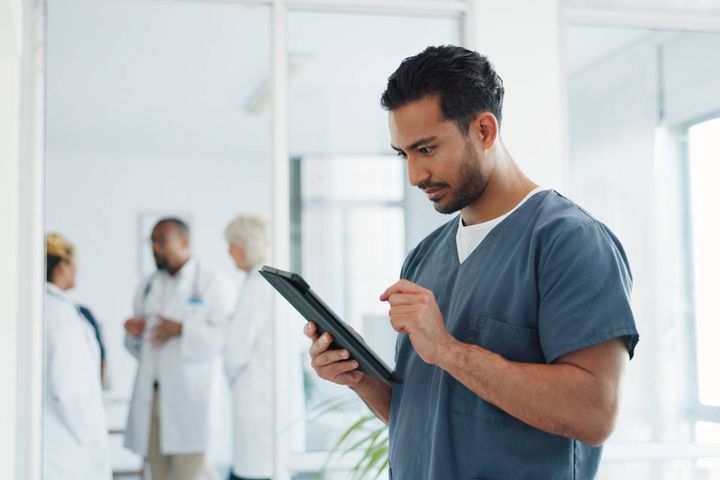 A nurse works on his NJ nursing license renewal process.