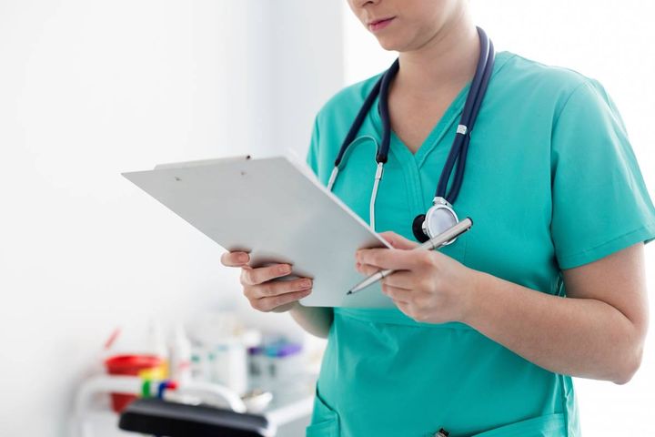 A healthcare professional uses their nurse accessories at work.