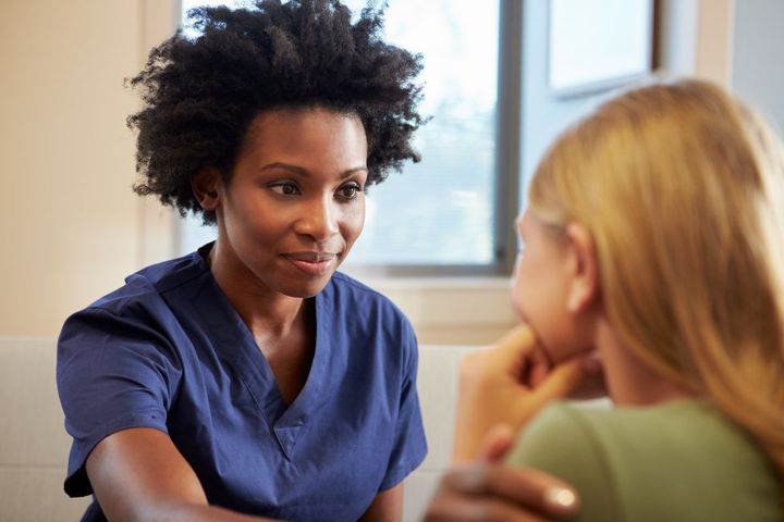 Nurse actively listening to a patient