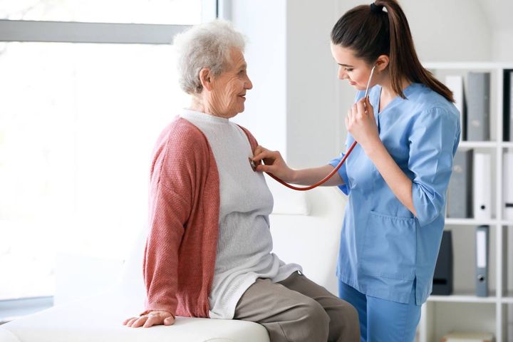 A nurse clinician assesses a patient's heartbeat.