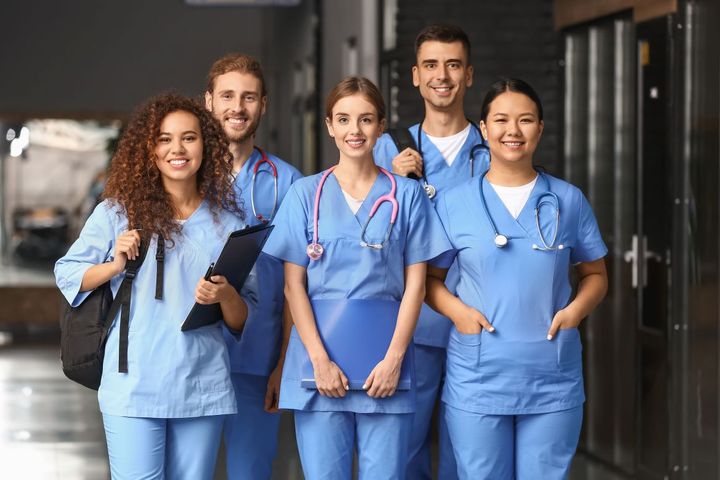 A group of new hires, smiling because they just signed generous nurse sign-on bonuses.