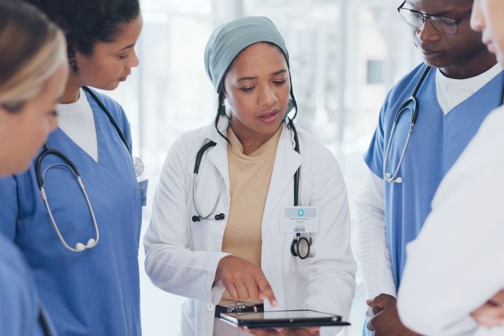 Nursing director talking to group of nurses in a healthcare facility