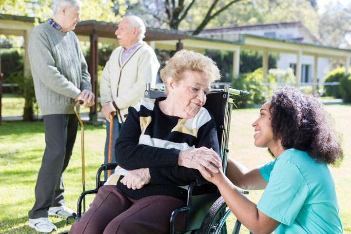 A nurse talks with a nursing home resident.