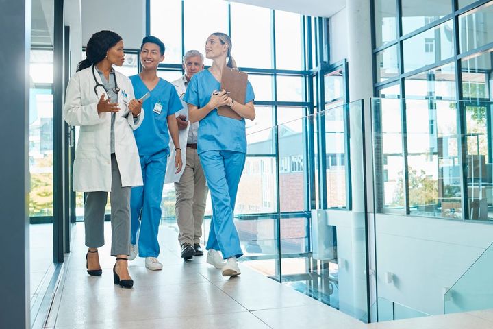 A nurse manager talks with her staff and goes over their nursing skills checklist.