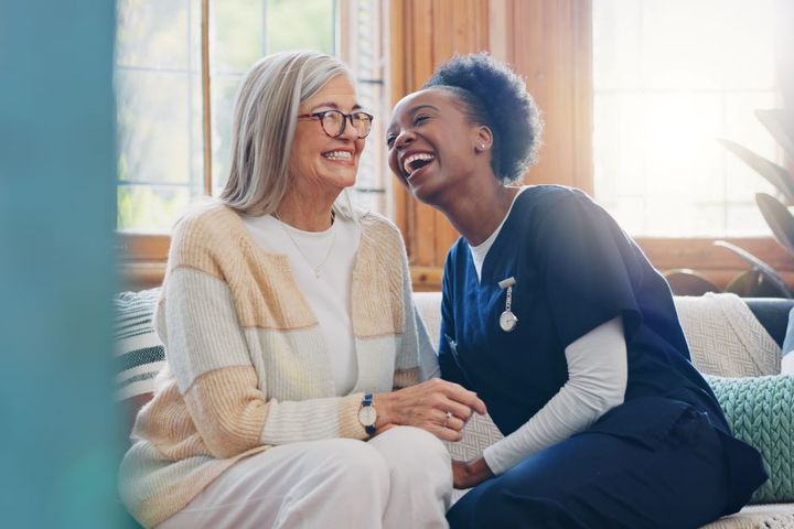 A CNA shares a laugh with an LTC center resident.