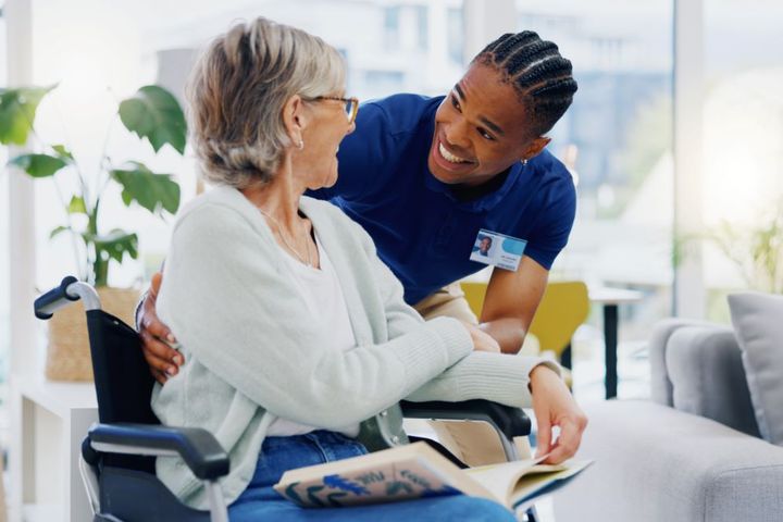 A nurse interacts with one of the residents at the nursing home where he works.