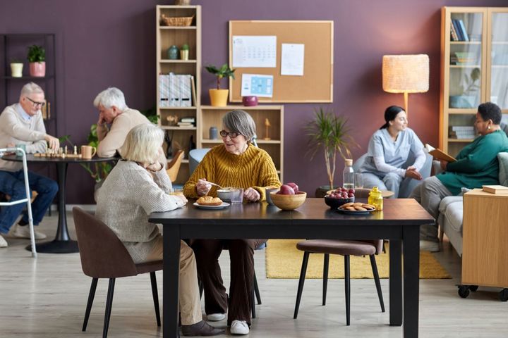 Nursing home residents enjoy a meal together.