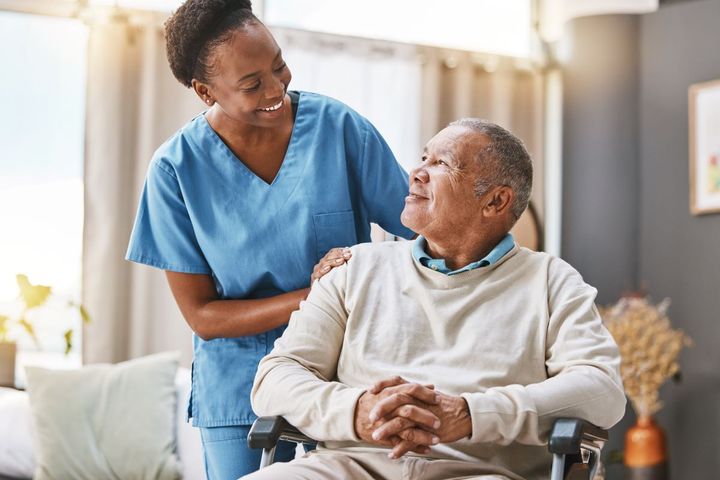 A nurse checks in on one of the residents at a nursing home.