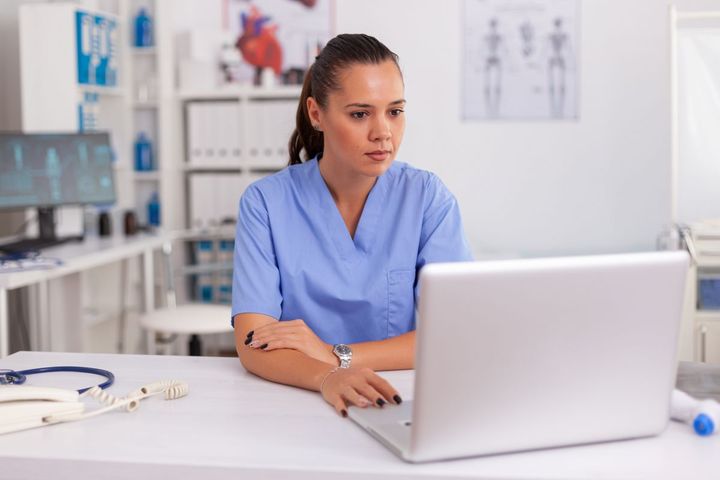 A nurse manager working on some online marketing tactics to help increase the visibility of her facility.
