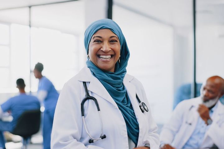 A patient flow coordinator smiling.