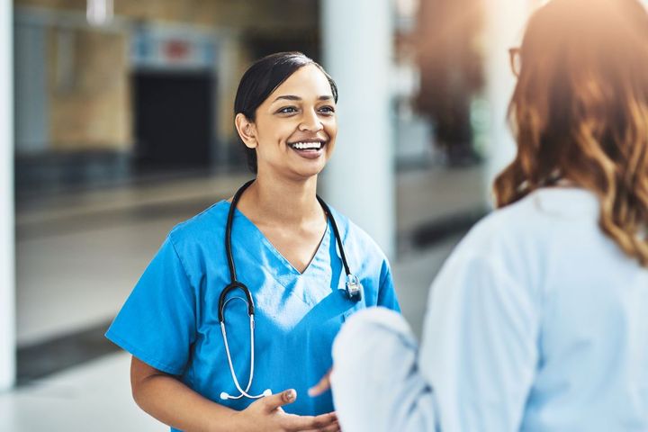 Physician and nurse discussing LPN scope of practice in a facility